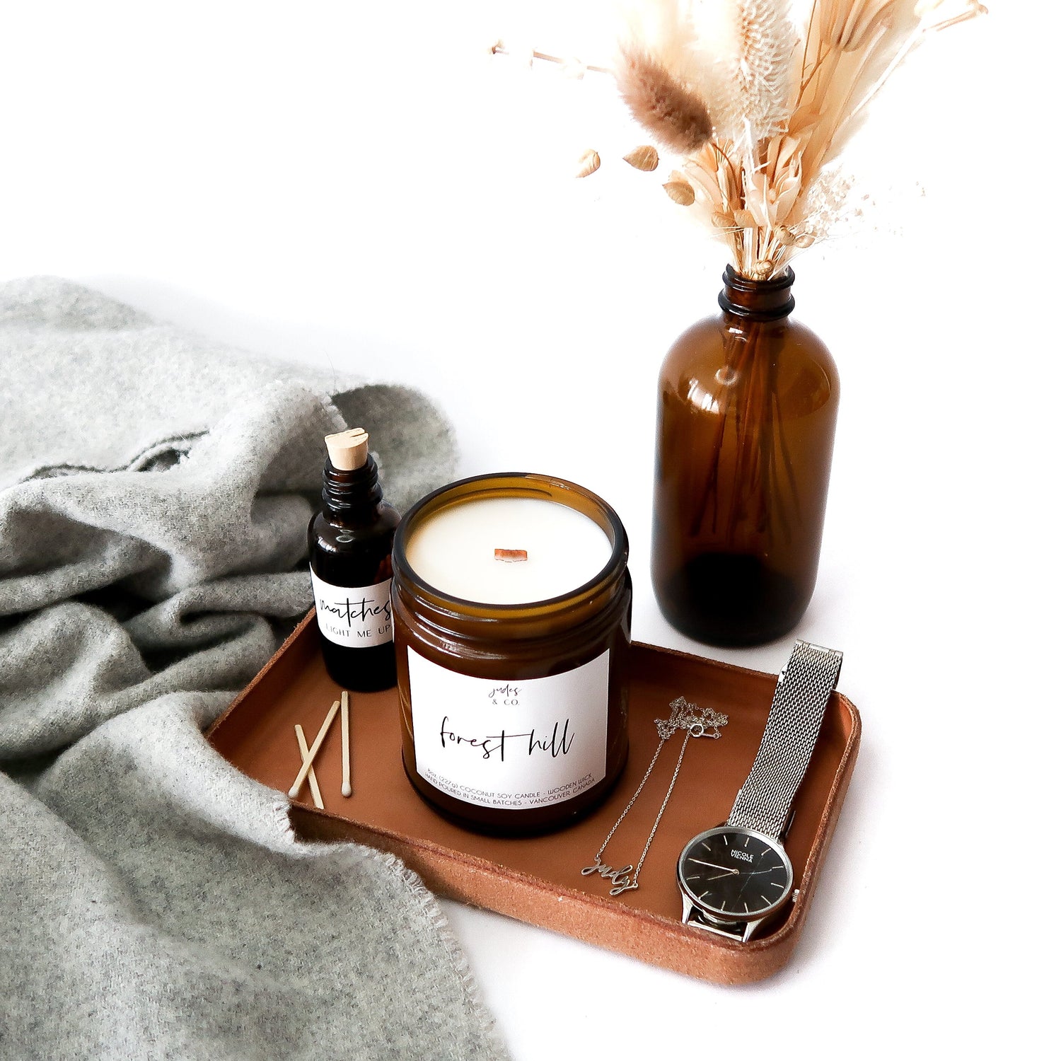Eco-friendly coconut soy candles with crackling wooden wick in amber glass jar.